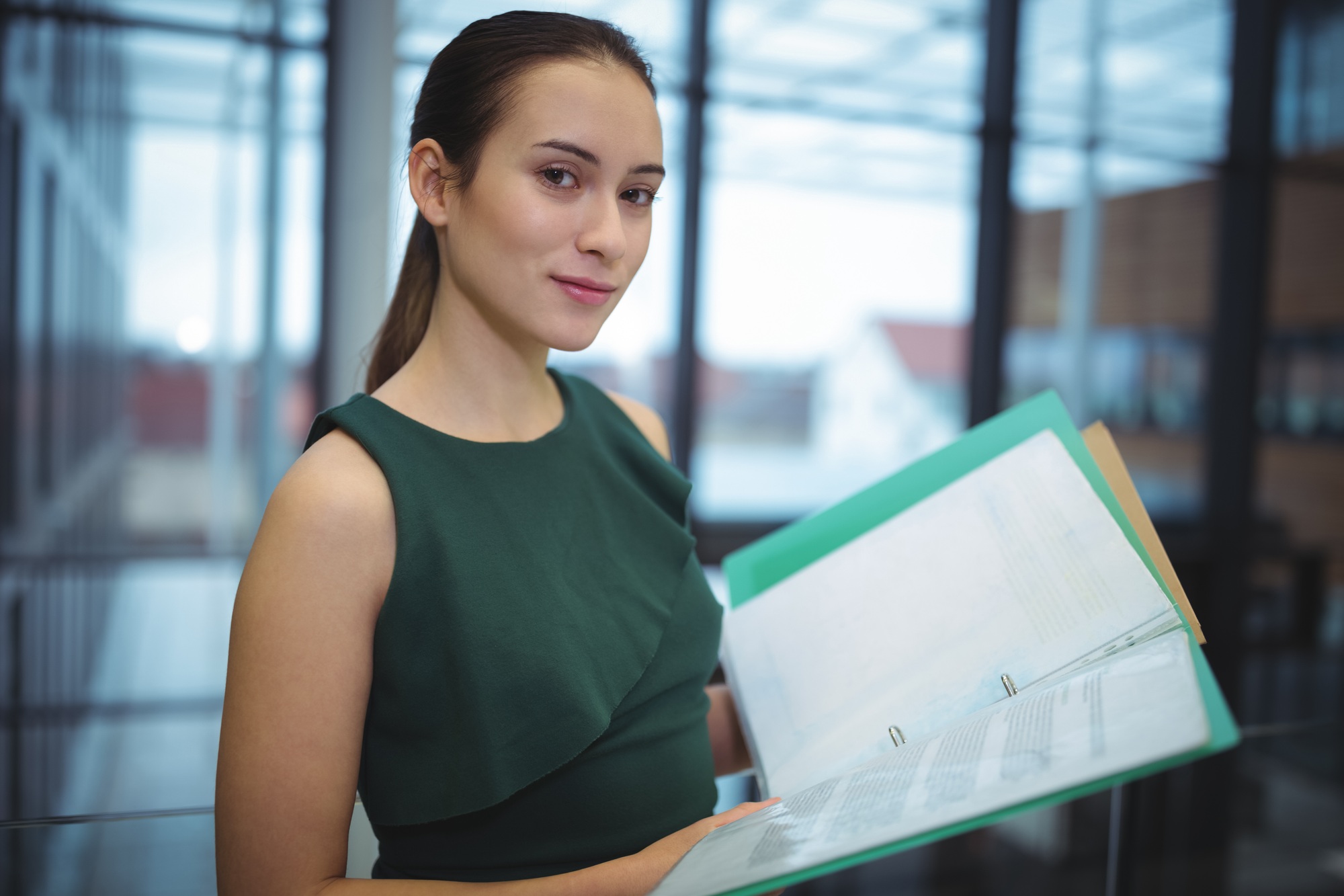 Businesswoman holding files at office