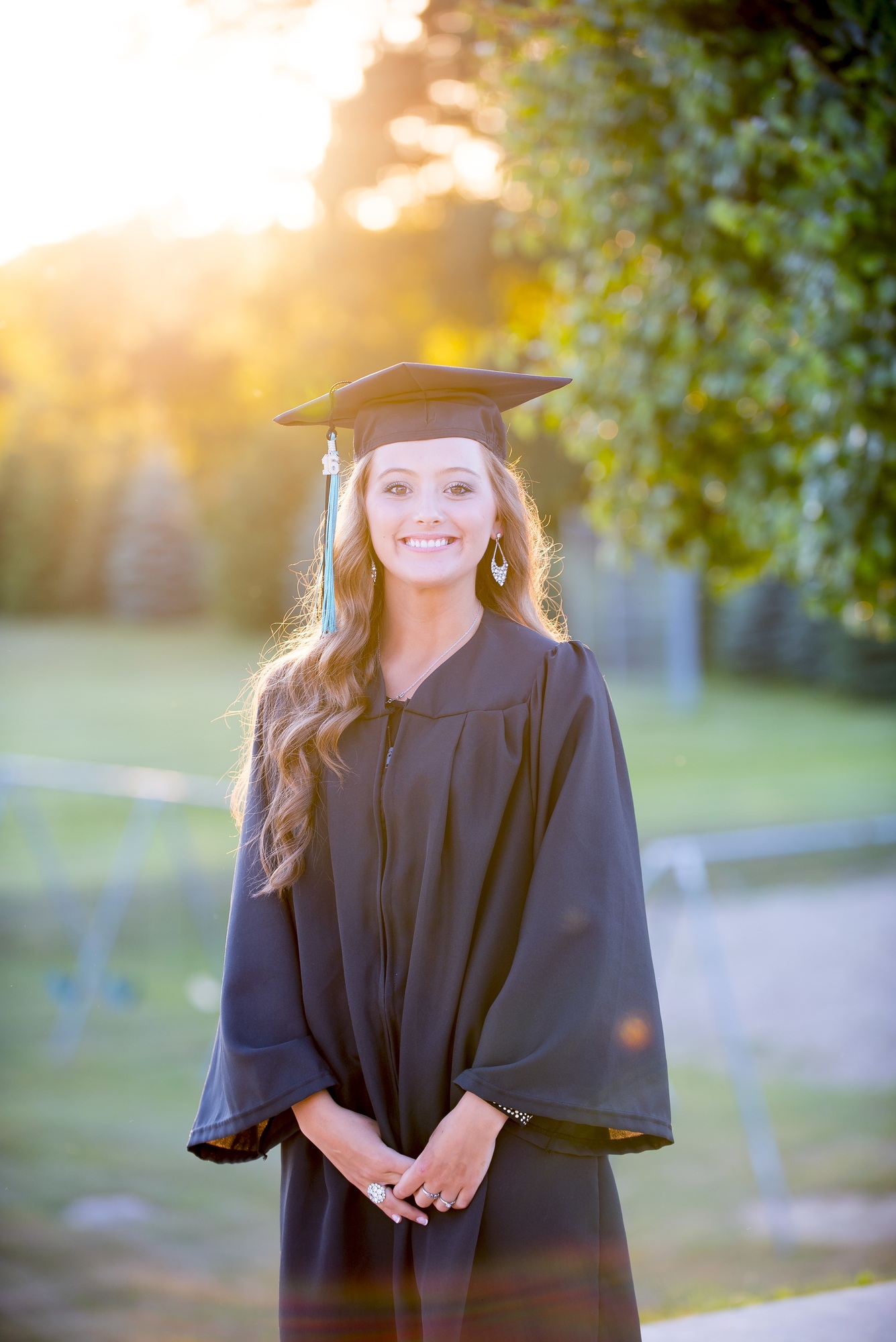 Vertical shot of a young attractive female graduate smiling at the camera